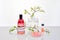 Natural Green laboratory. Abstract floral design. Orange liquid product, fragrance, perfume in transparent bottle