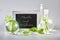 Natural Green laboratory. Text Health and Wellness on blackboard, chalk board. Exotic green leaves in transparent glass