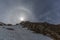 Natural halo with sun in blue sky and snowy mountains