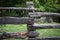 Natural hand made fence made of wooden tree brenches. Close up view of village fence with moss on wooden surface