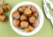 Natural hazelnuts in bowl with nut cracker aerial