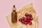 Natural healthy organic cosmetics, fruits, cherries, bottle with cosmetic product on pink background