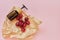 Natural healthy organic cosmetics, fruits, cherries, bottle with cosmetic product on pink background