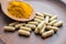 Natural herb food supplement turmeric veggie capsules and spoon