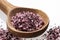 Natural hibiscus salt in wooden spoon - fine crystals for seasoning