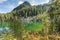 A natural hiden mountain lake among the woods in the Italian Alps