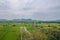 Natural high angle views, rice fields with sky and mountains behind Kanchanaburi, Thailand