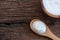 Natural homemade plain organic yogurt in wooden bowl and wood spoon on wood texture background