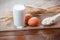 Natural homemade products: milk, cheese, sour cream and eggs on old wooden background