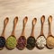 Natural ingredients Collection of beans and sesame on wooden spoons