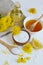 Natural ingredients for homemade body salt scrub with dandelion flowers, lemon, honey and olive oil