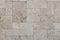 Natural Italian stone. Smooth travertine surface. A sample of wall cladding with natural stone.