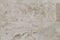 Natural Italian stone. Smooth travertine surface. A sample of wall cladding with natural stone.