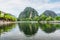 Natural karst towers reflected in the Ngo Dong River, Vietnam