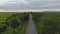 Natural landscape of asphalt road of local significance road between fields.