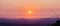 Natural landscape background of sunrising over mountains with orange sky