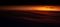 Natural landscape of colourful sunset with dark clouds. Panoramic banner view