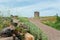 Natural landscape with old windmill and local person bike. Beautiful scene on green country hill