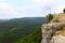 Natural landscape photo of mountain cliff alone with the sky and slopes in distance