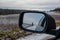 natural landscape reflection in cars mirror