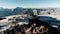 Natural landscape with snowy rocks and shelter for hikers. Clip. View from the hill top on a small camp base for