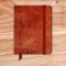 Natural Leather Notebook On A Wooden Desk. Copybook With Band