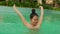 Natural lifestyle shot on young happy and beautiful Asian Korean woman in bikini enjoying Summer holiday getaway at luxury hotel