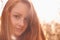 Natural light brings out her best. Cropped portrait of a beautiful young redhead in nature.