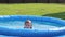 Natural lighting. bright sun. A girl in a swimsuit is swimming in a small pool. Close-up