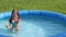 Natural lighting. bright sun. A girl in a swimsuit is swimming in a small pool. Close-up