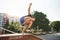 Natural lighting. Young sports man doing parkour in the city at sunny daytime