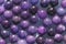 Natural Lilac and violet mineral stones beads. Lilac and violet natural background made of round stone beads