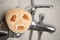 Natural loofah sponge on faucet in bathroom, closeup