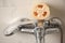 Natural loofah sponge on faucet in bathroom, closeup