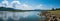 A natural masterpiece: panoramic view of dam, mountains, and clear blue sky