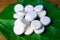 Natural medical pill made from herbs and plants, white pills on a green leaf