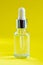 Natural medicine or aroma oil or beauty essence concept vial with dropper background. Face and body