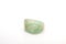 Natural mineral from geological collection - raw green Beryl crystal on white background.