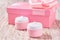 Natural moisturizer cream or body lotion cosmetic series of premium moisturizing and nourishing cosmetics. Plastic pink jars of