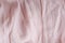 Natural nude gentle pink, light pastel textile cloth background, crumpled wavy texture