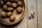 Natural nuts and in a stylish unique rustic bowl on a wooden b