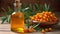 Natural oil of sea buckthorn Hippophae in glass bottle with branch of fresh, juicy ripe yellow berries with green leaves on a