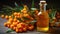 Natural oil of sea buckthorn Hippophae in glass bottle with branch of fresh, juicy ripe yellow berries with green leaves on a