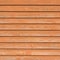 Natural old wood fence planks, wooden close board texture, overlapping light reddish brown closeboard terracotta background