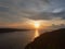 Natural Orange Sunset Colorful Sky lake.Sun Over Skyline Mountain Water in crest shape and beautiful clouds