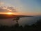 Natural Orange Sunset Colorful Sky lake.Sun Over Skyline Mountain Water in crest shape and beautiful clouds