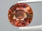 natural orange tourmaline dravite gem on the background