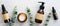 Natural organic cosmetics in amber glass bottles in row on stone table with eucalyptus. Beauty blog banner design. Skin care