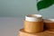 Natural organic cream moisturizer in bamboo eco-friendly jar.