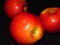 Natural organic healthy fruit. Close up of three ripe red juicy apples on black background.